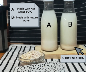 TWO OAT MILK BOTTLES ON A TABLE ONE OF THEM WITH OVIOUS SEDIMENTATION